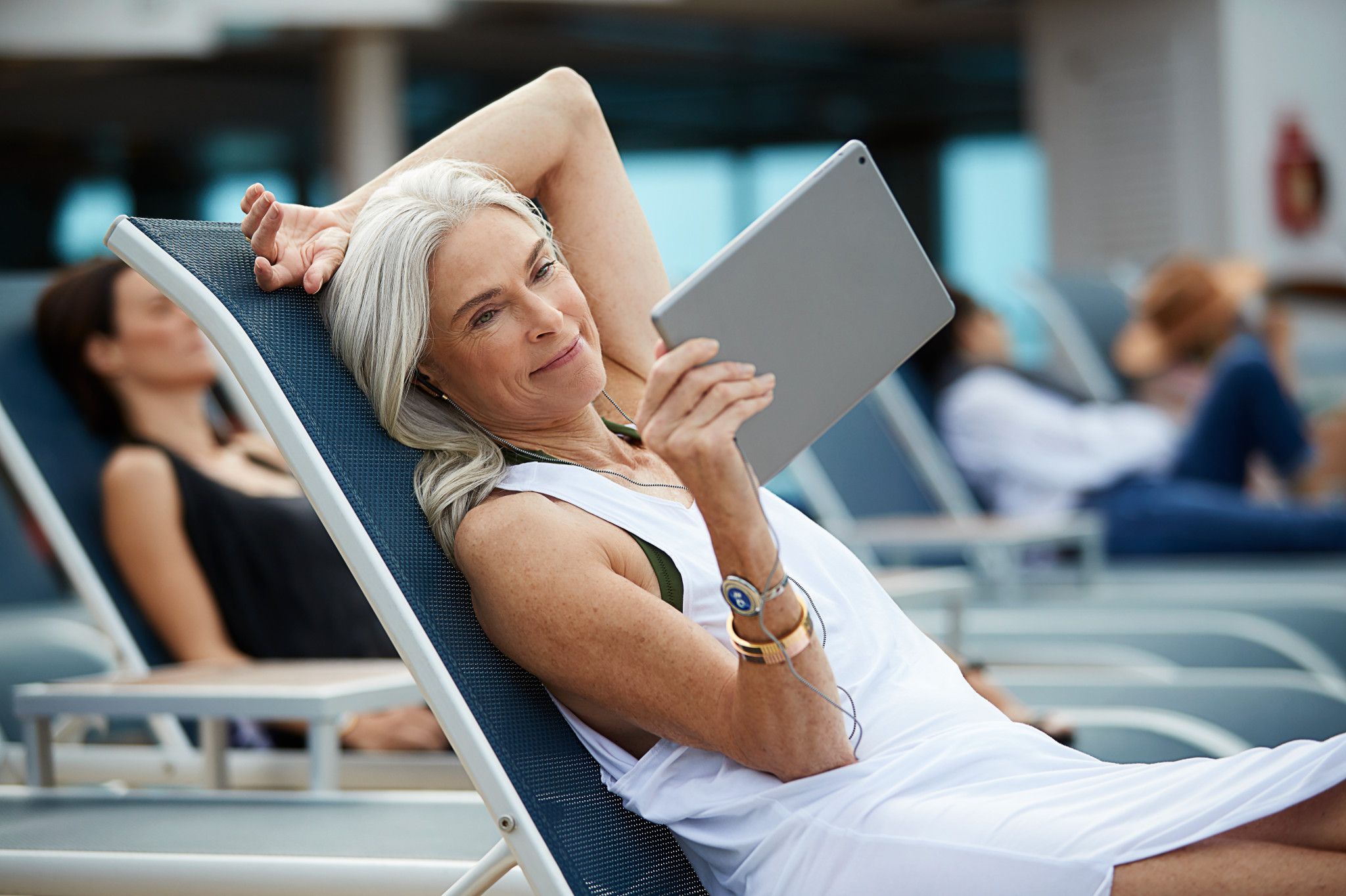 Women relaxing with tablet outdoors